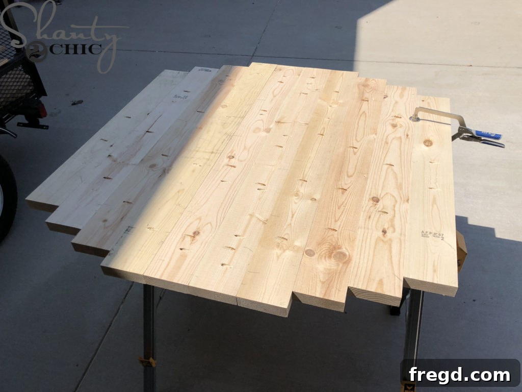 Attaching the two central planks of the tabletop using pocket screws and a Kreg Jig Face Clamp for flush alignment