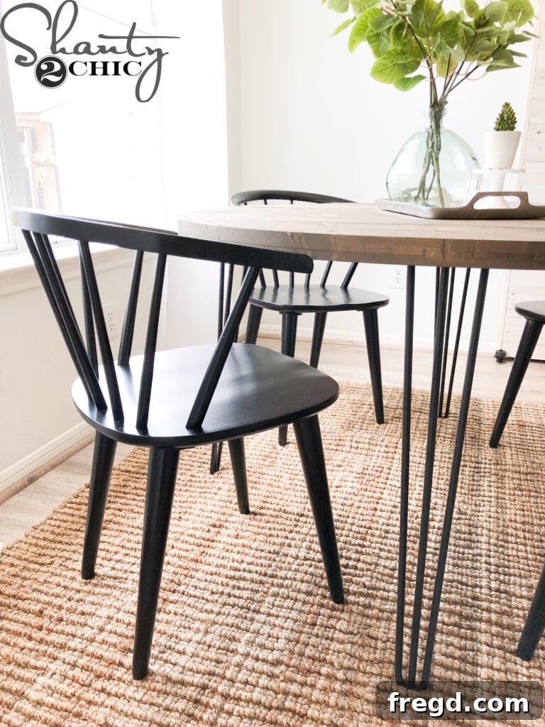 A wide shot of the stylish kitchen featuring the newly built DIY round hairpin table and surrounding decor