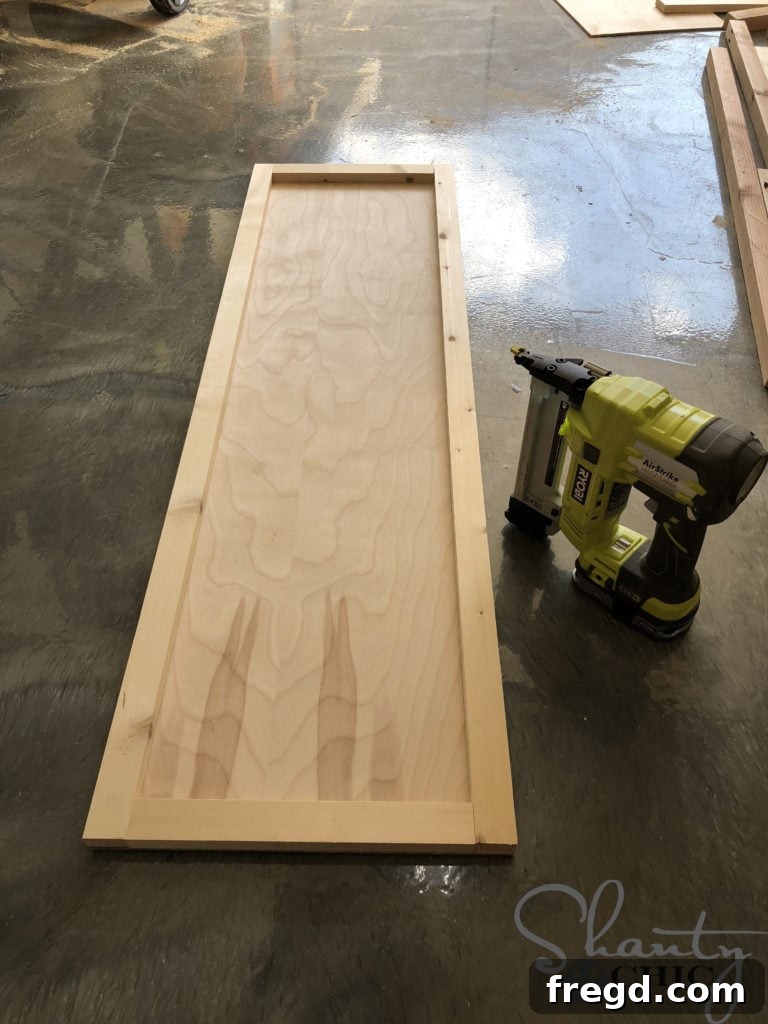Attaching plywood backing to mirror frame side pieces with staples and wood glue