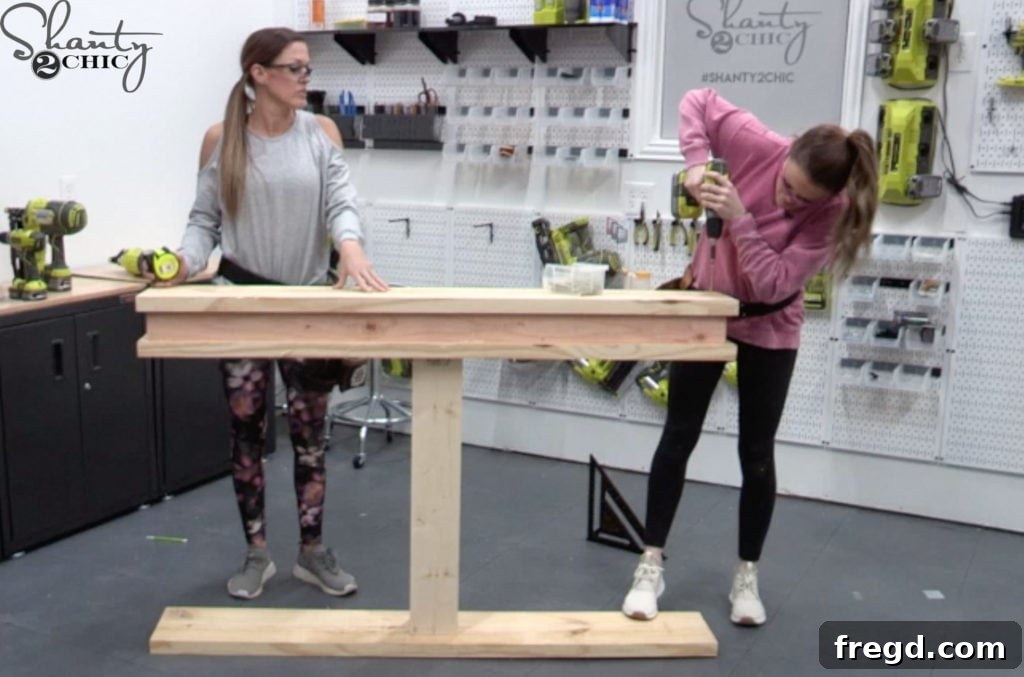A new plank being centered and attached on top of the bottom apron using wood screws and glue, providing additional support and structure.