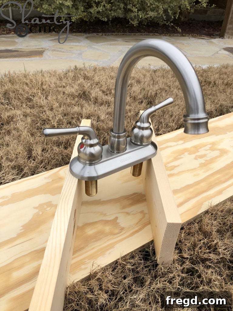 Spray painting the play kitchen faucet in modern gold