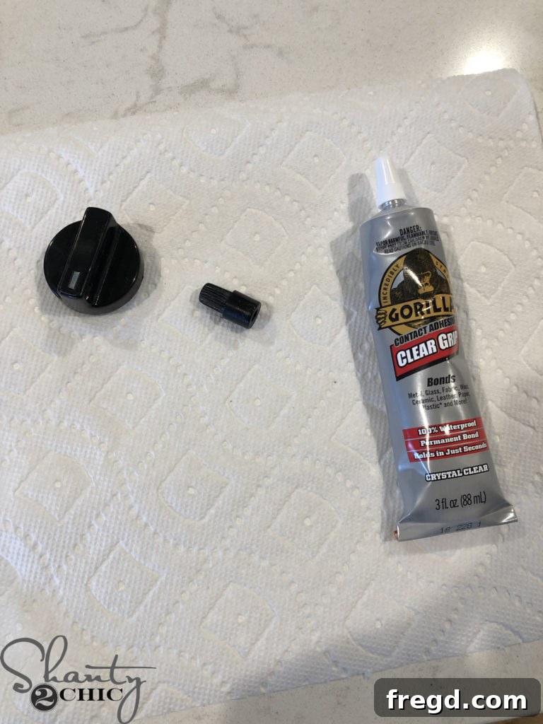 Gluing the plastic piece to the play kitchen knob