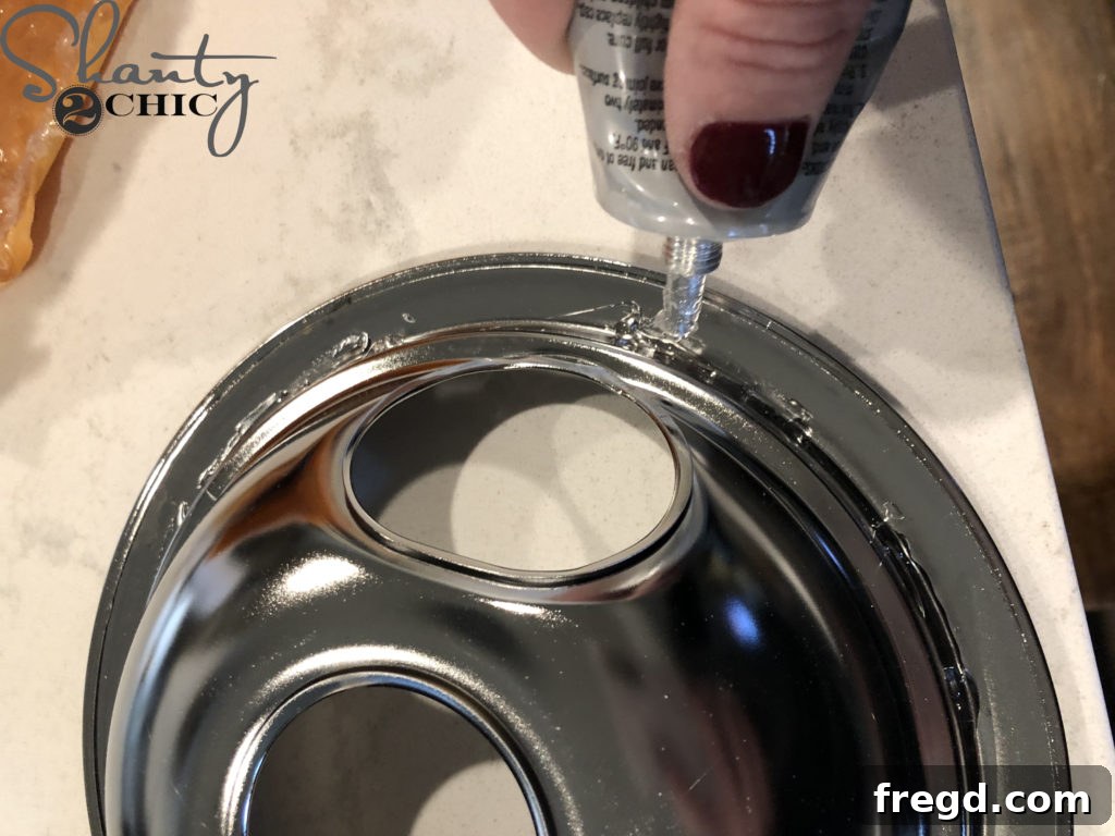 Applying adhesive to stove burner drip bowls