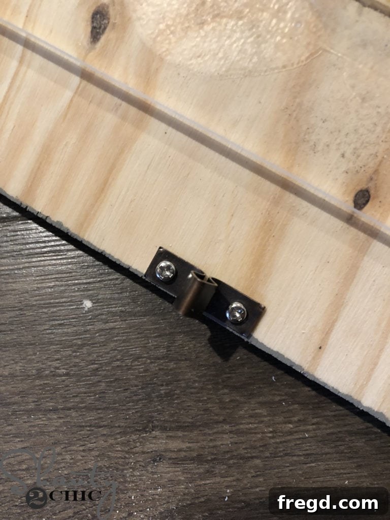 Securing the other side of the oven door catch to the door