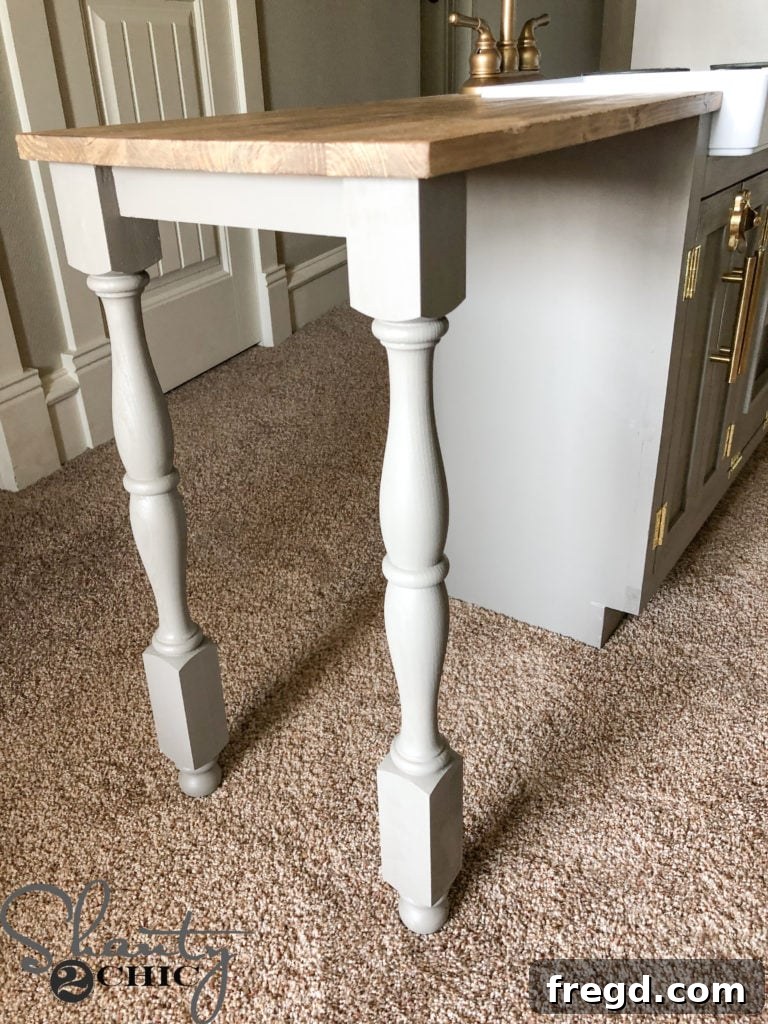 Elegant table legs extending the play kitchen countertop into a peninsula