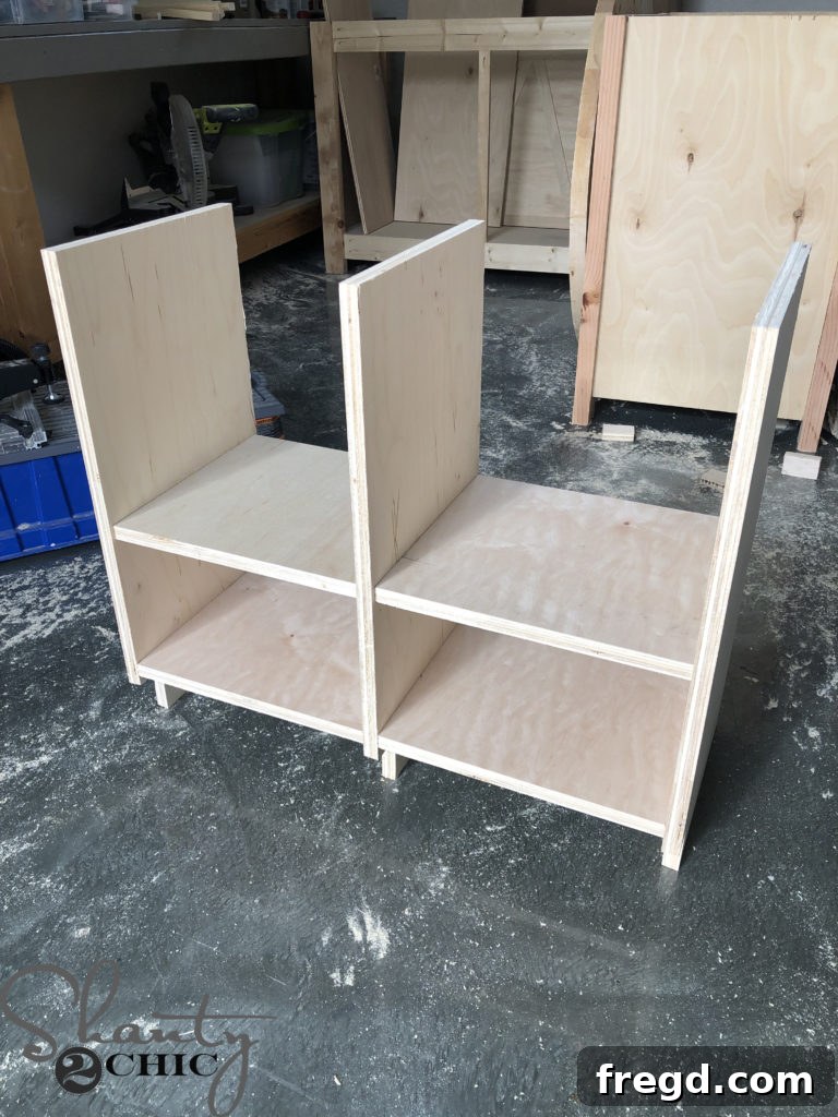 Securing the final side panel of the play kitchen cabinet