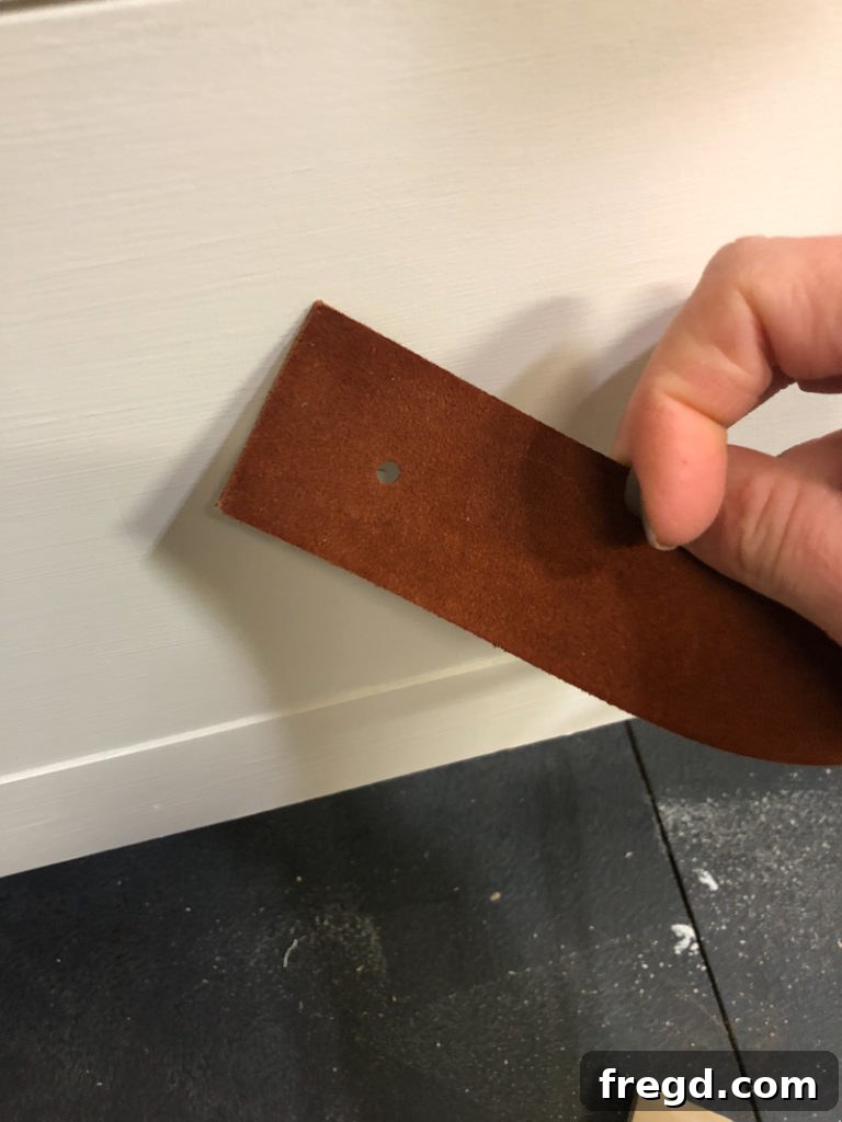 Custom leather strips cut and drilled for drawer pulls