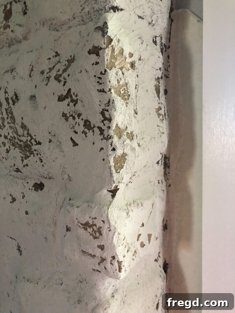 Close-up of rough mortar edges and brush strokes on fireplace