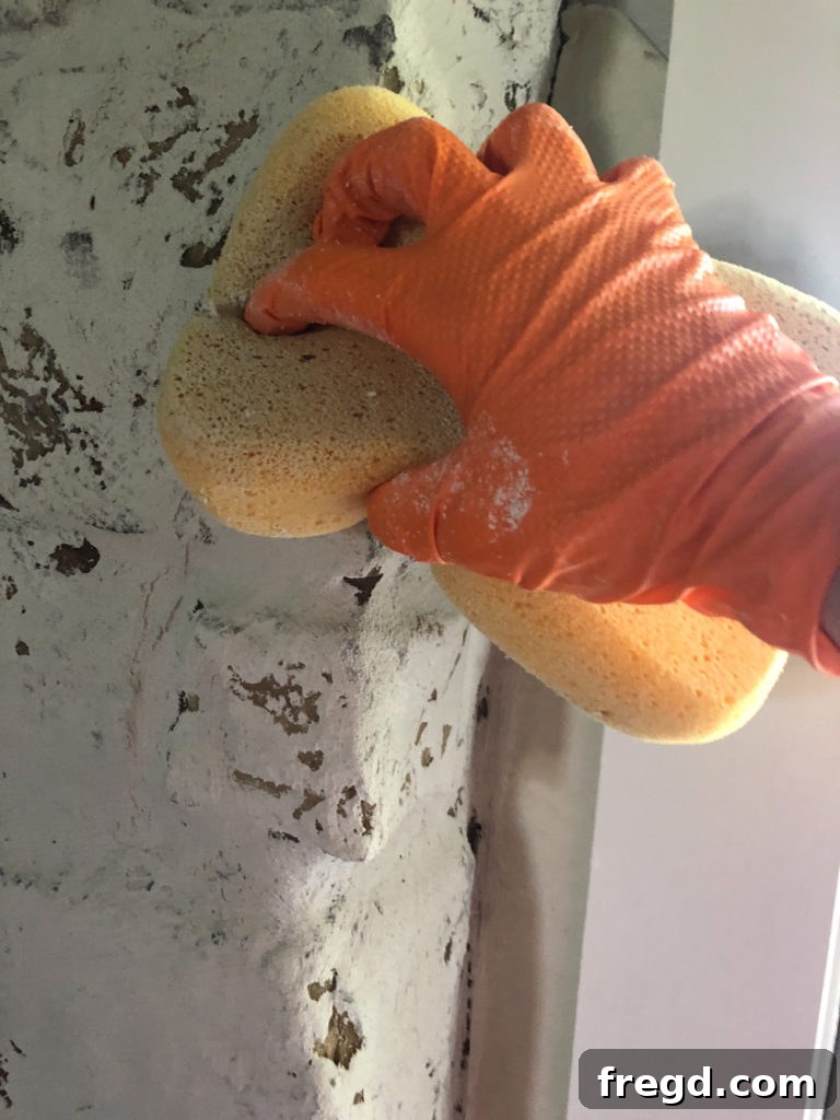 Smoothing rough mortar areas and brush strokes with a wet sponge
