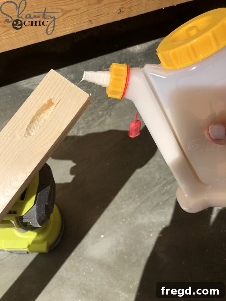 Applying wood glue to the ends of the barn door stud pieces