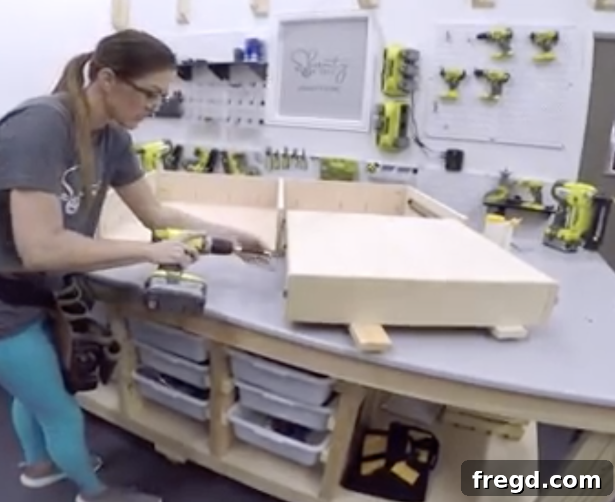 Securely attaching the completed drawer boxes to their respective slides.