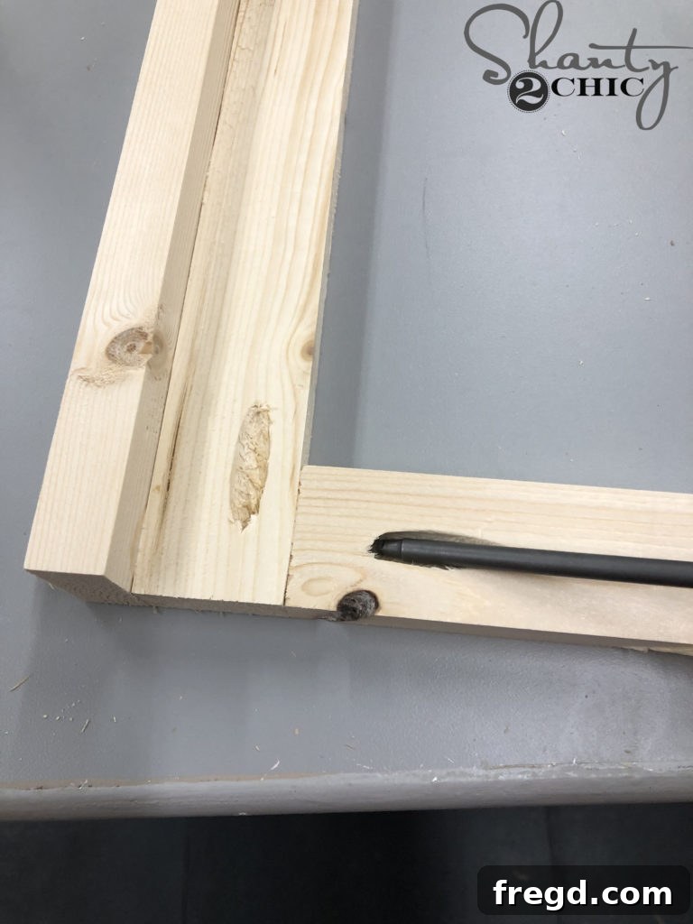 Attaching horizontal frame pieces with pocket hole screws and wood glue.