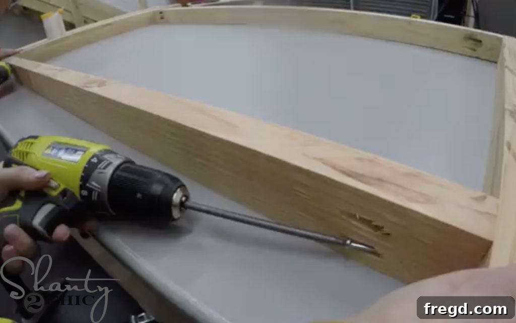 Assembling headboard pieces with pocket hole screws and wood glue.