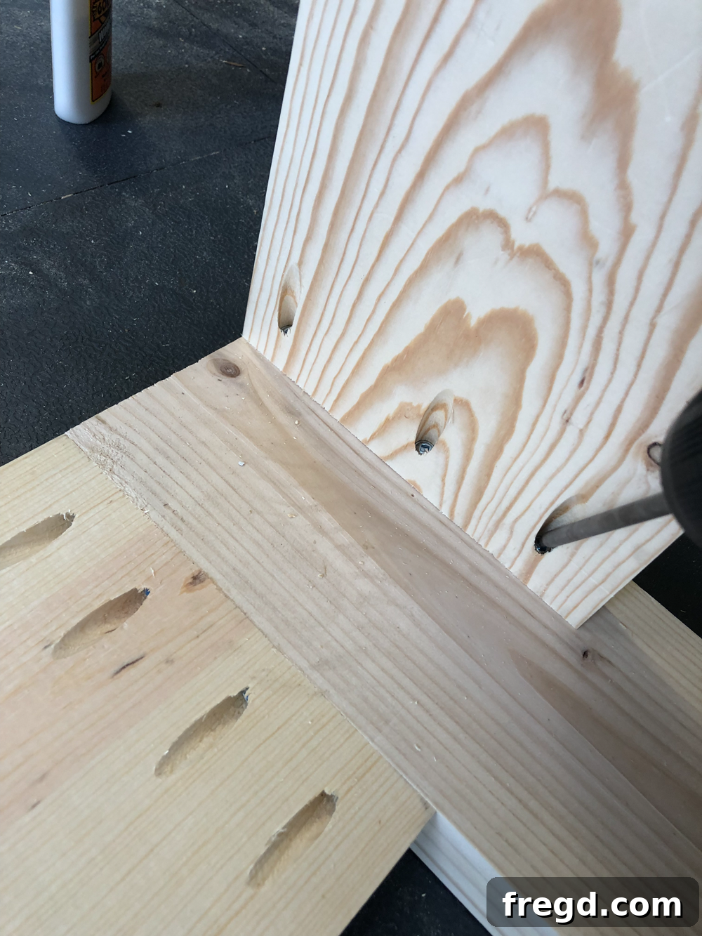 Build Your Own Faux Drawer Console Table 21 Close-up of a pocket hole screw being driven into a shorter apron for a strong joint.