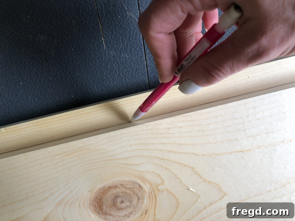 Build Your Own Faux Drawer Console Table 6 Using a scrap board to mark a straight line for precise drawer face placement.