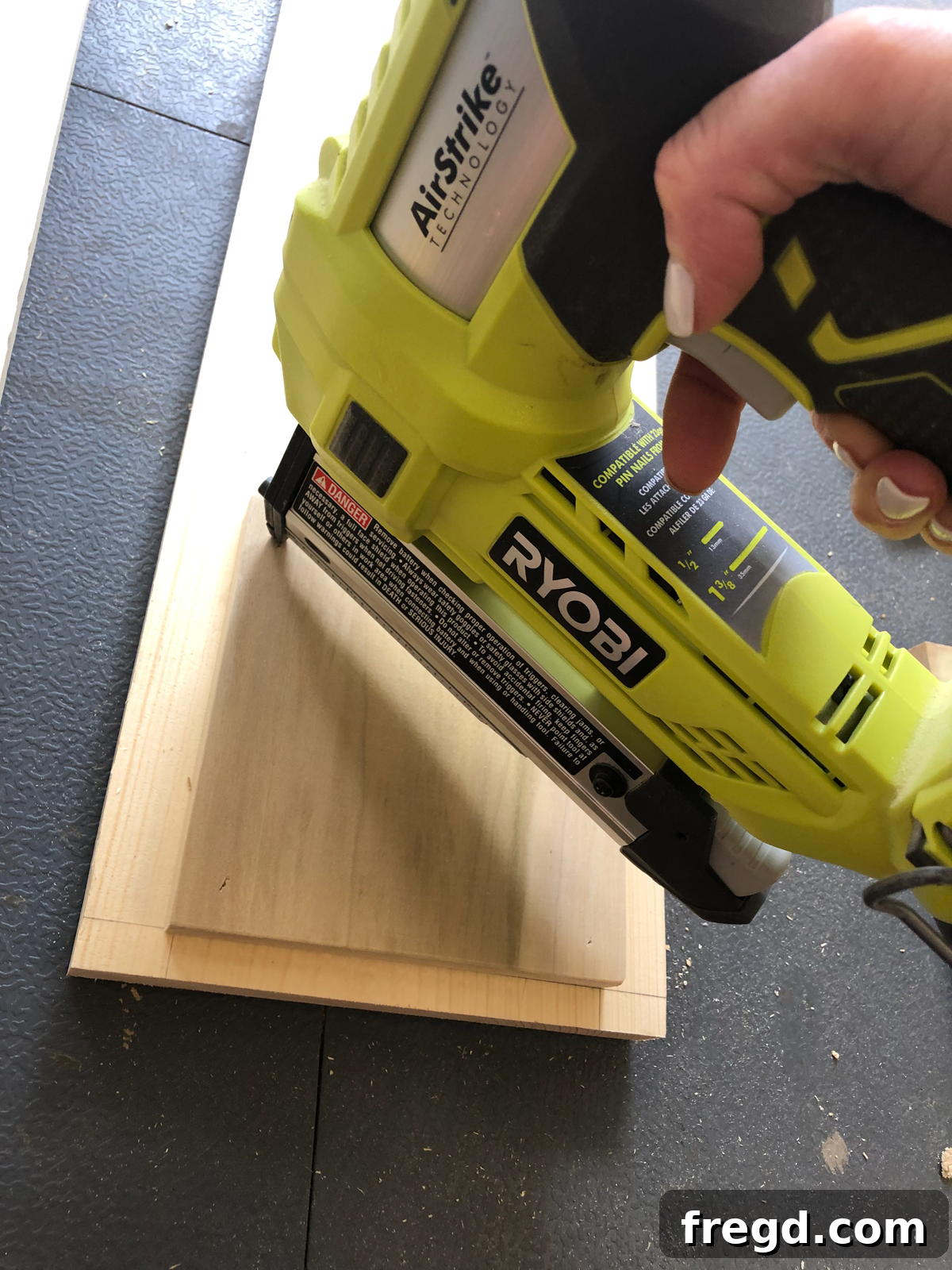 Build Your Own Faux Drawer Console Table 9 Detailed shot of a Ryobi pin nailer in efficient operation.