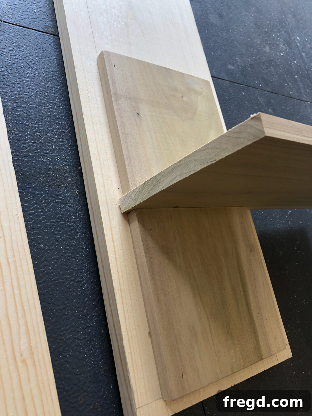 Build Your Own Faux Drawer Console Table 10 Using a scrap piece of wood as a spacer for consistent, even drawer face gaps.