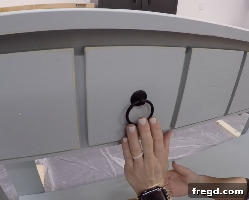 Close-up of decorative ring pulls installed on the faux drawer faces
