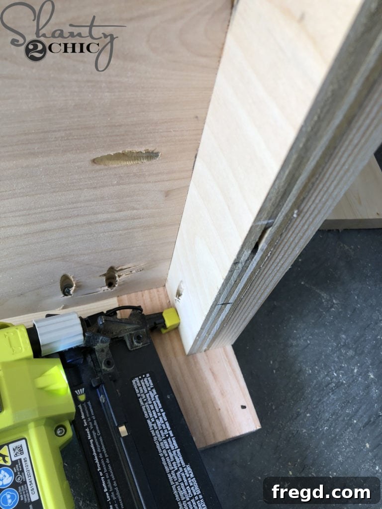 DIY Rustic Double Sink Bathroom Vanity with Barn Door Storage 28 Attaching the side trim on the bathroom vanity cabinet