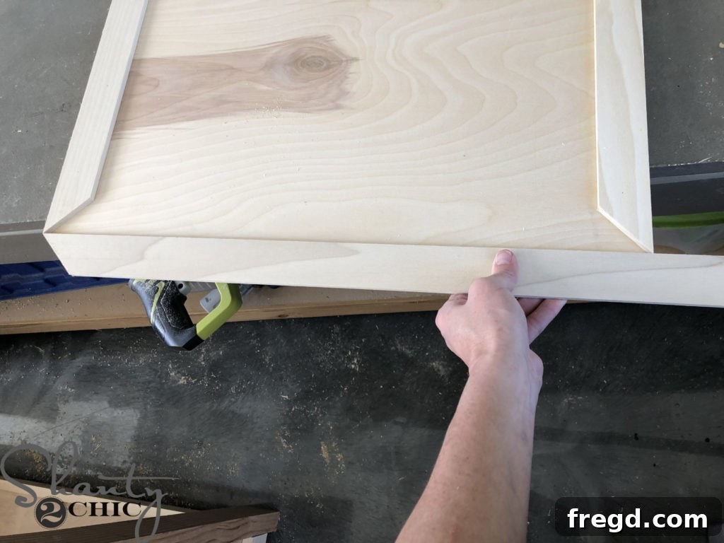 DIY Rustic Double Sink Bathroom Vanity with Barn Door Storage 30 Measure and cut for the trim on barn doors