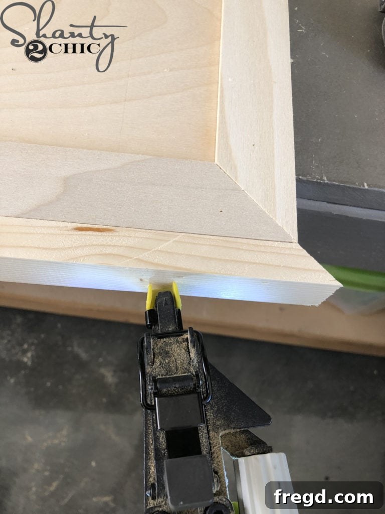 DIY Rustic Double Sink Bathroom Vanity with Barn Door Storage 33 Attaching the trim to the barn door