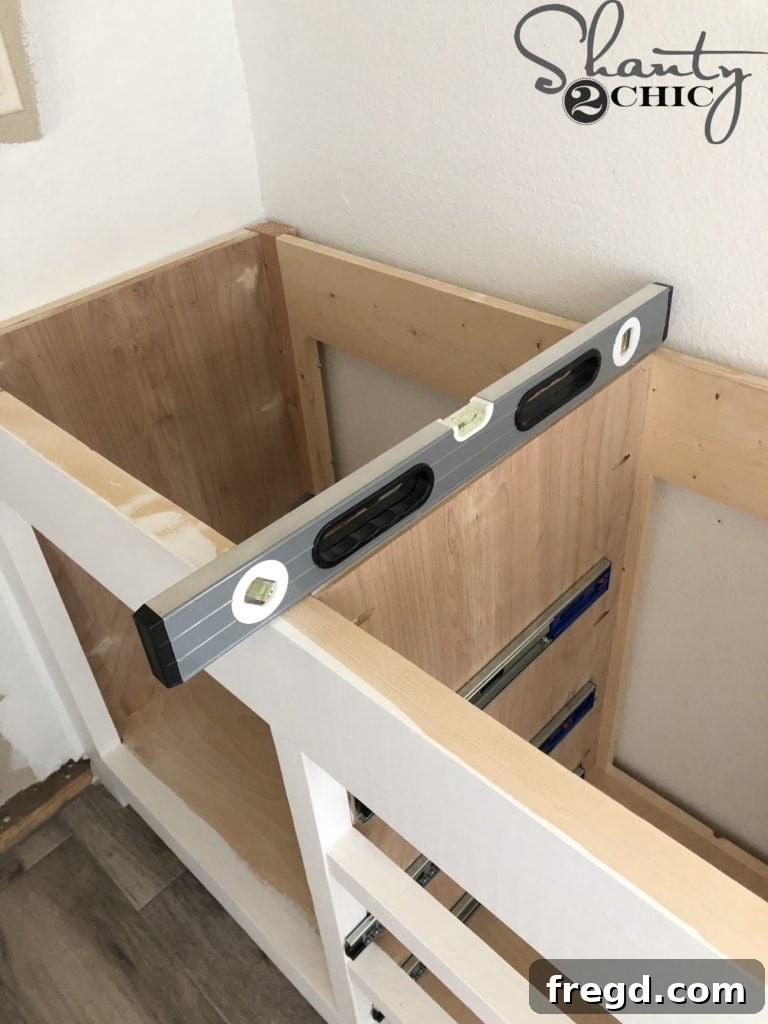 DIY Rustic Double Sink Bathroom Vanity with Barn Door Storage 45 Leveling the bathroom vanity during installation