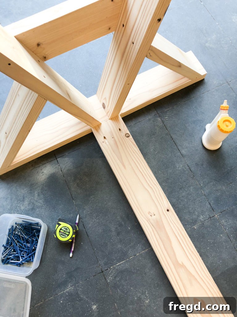 Sawhorse Chic: A DIY Modern Farmhouse Dining Table 21 Detail of pocket hole screws securing the central runner to a leg assembly