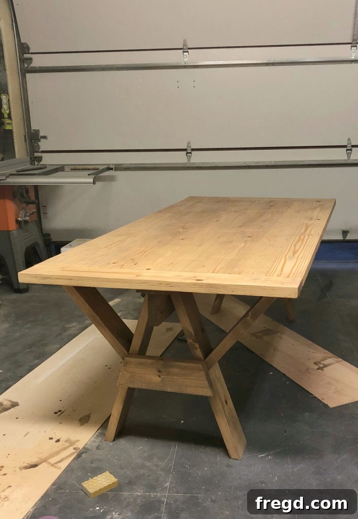 Sawhorse Chic: A DIY Modern Farmhouse Dining Table 28 Close-up of the beautifully stained modern farmhouse dining table surface