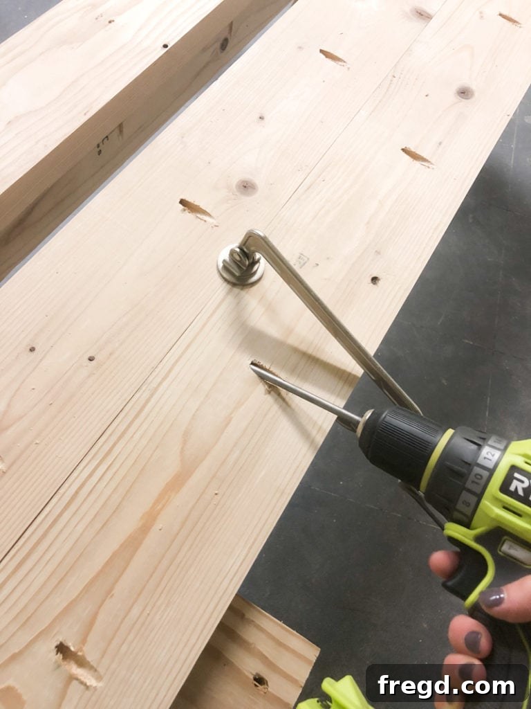 Sawhorse Chic: A DIY Modern Farmhouse Dining Table 4 Detail shot of a Kreg Face Clamp holding two wood planks flush during assembly