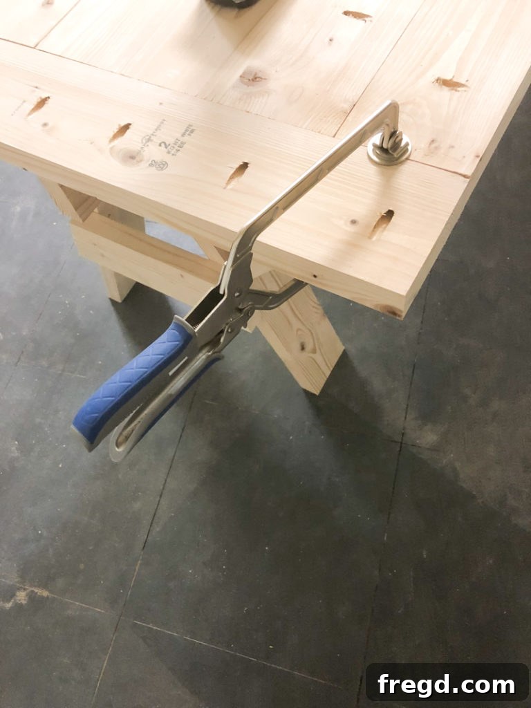Sawhorse Chic: A DIY Modern Farmhouse Dining Table 5 Kreg Face Clamp used to secure a breadboard to the end of a table plank