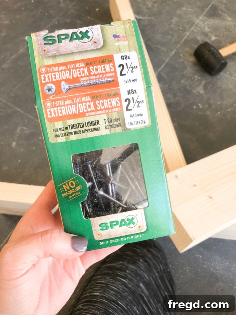 Sawhorse Chic: A DIY Modern Farmhouse Dining Table 6 Detailed shot of woodworking with Spax screws and a drill