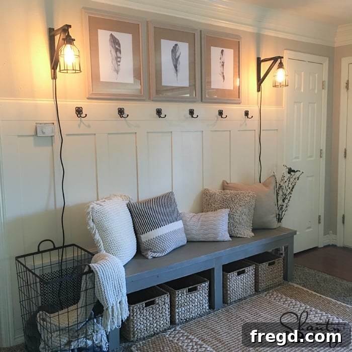 After photo of Kyndra's renovated entryway featuring a DIY storage bench and board and batten wall treatment, creating an organized mudroom feel.