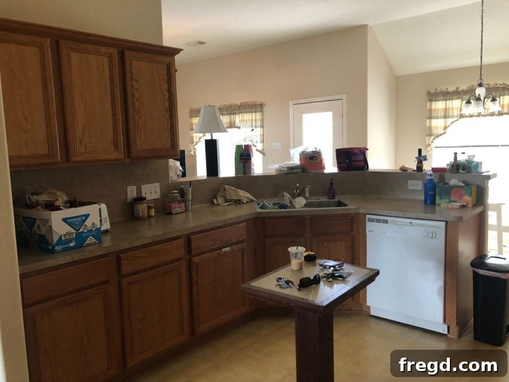 Another view of the renovated kitchen showcasing the taller, painted cabinets and refreshed aesthetic.