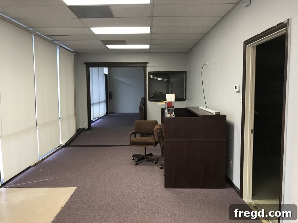 Before photo of an old, generic office space, soon to be renovated into a jewelry shop.