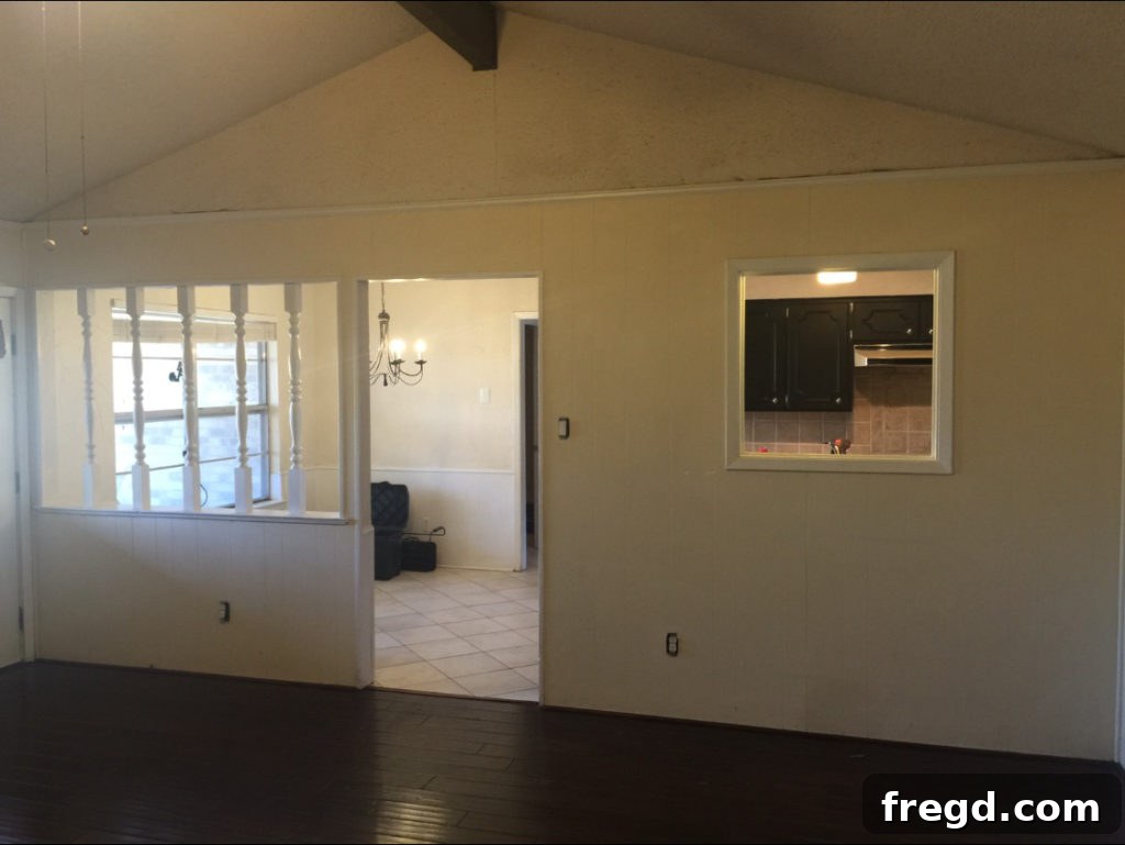 Before photo of the Berry House kitchen with an inconvenient service window separating it from the living space.