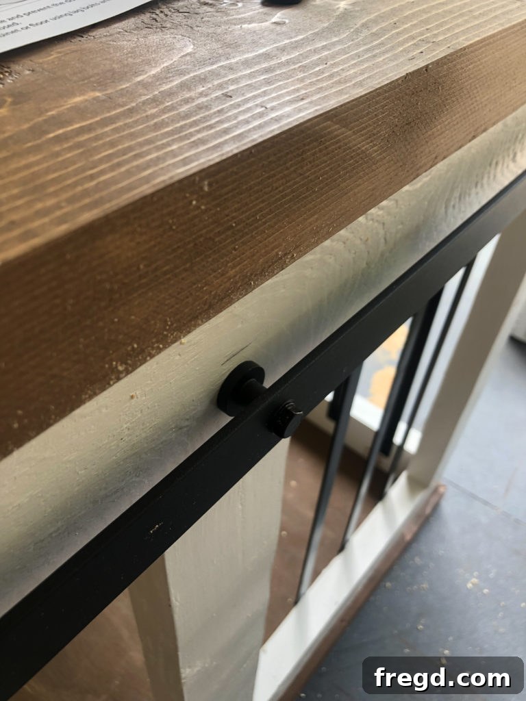 Close-up of the elegant barn door pull handle and the overall finish of the custom dog crate