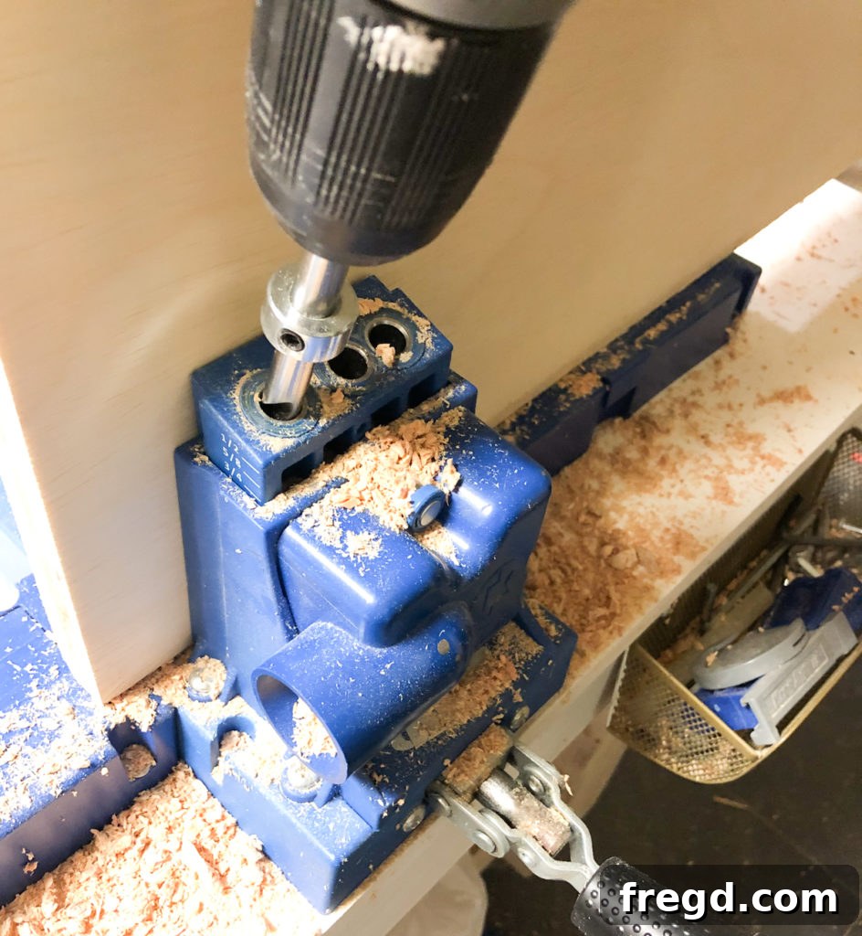 Adding 3/4-inch pocket holes along all edges of the plywood base for the dog crate