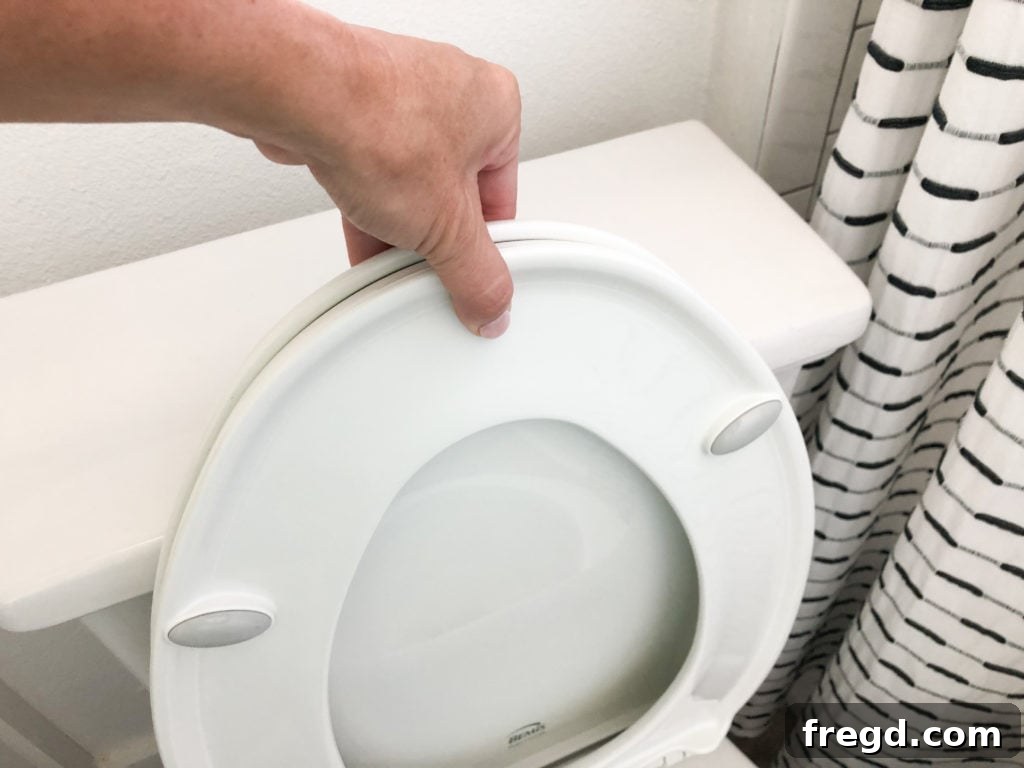Pushing toilet seat down to release