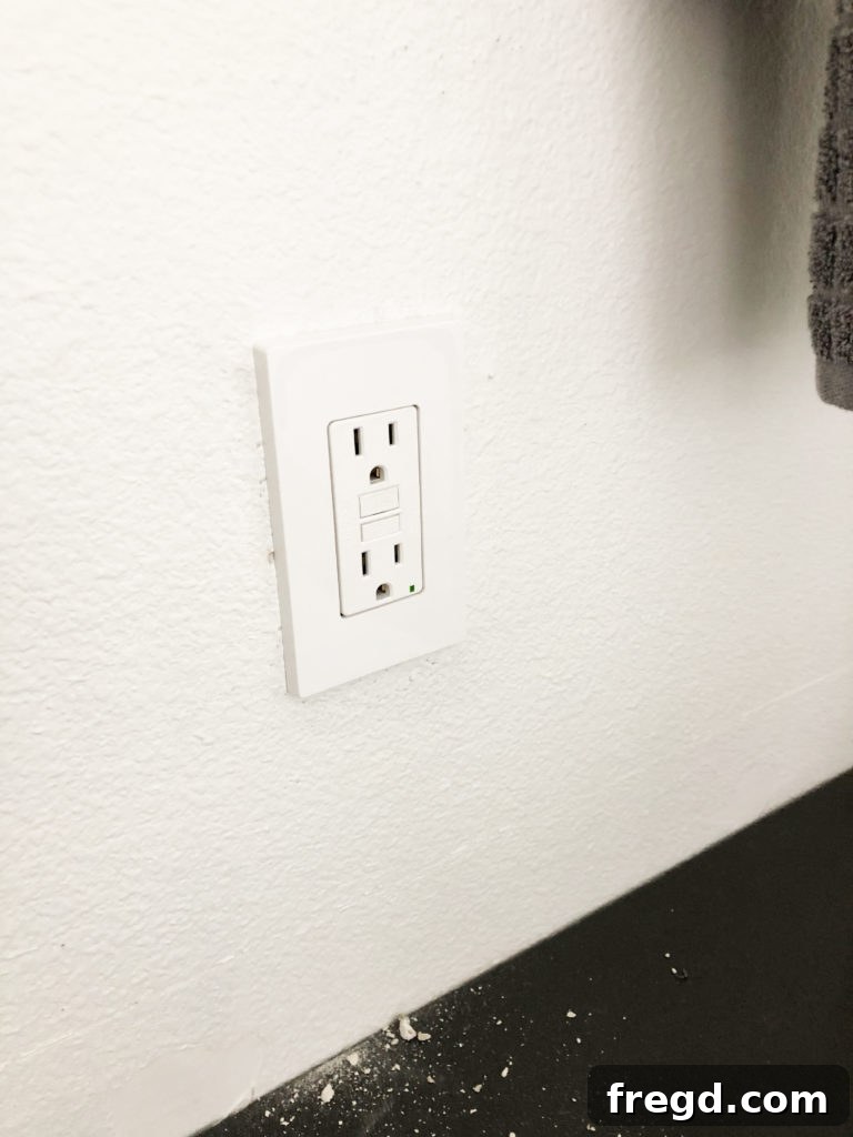 White electrical outlet in modern bathroom
