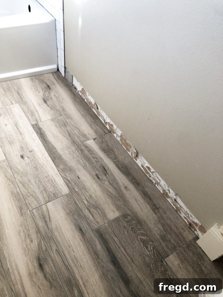 Wood-look tile being installed in bathroom