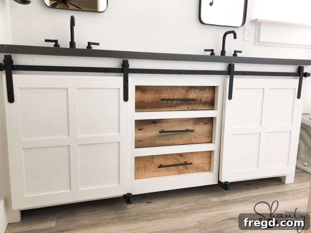 New double vanity with gray floors and black hardware