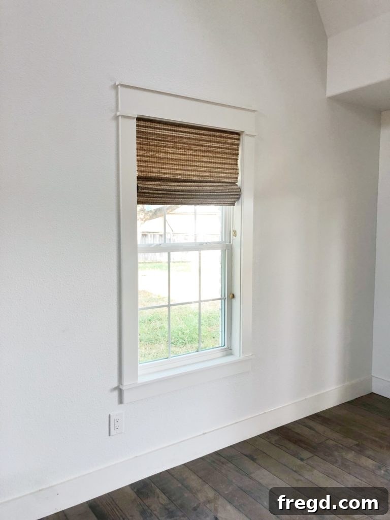 Shanty2Chic Tackles Flip House Four 8 Vertical shot of a great room corner with Graber natural shades, showcasing a comfortable seating area and elegant interior design details in a farmhouse home.
