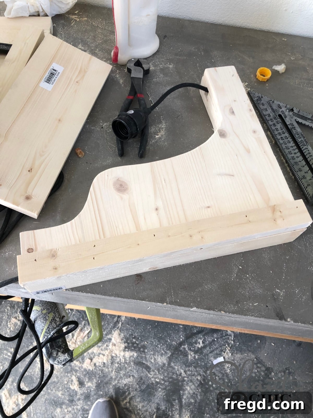 The Shanty Flip Episode 6 14 Attaching the 1x2 side trim pieces to the corbel, using the cleat as a guide