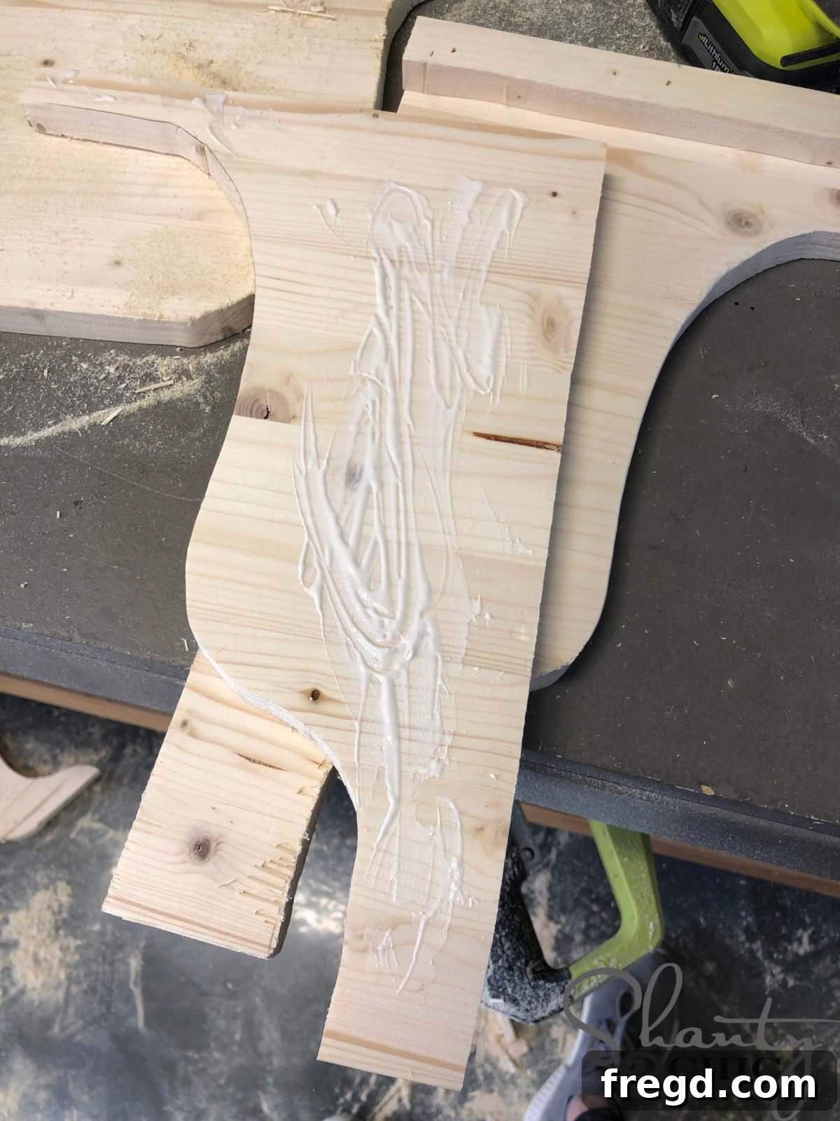 The Shanty Flip Episode 6 9 Applying wood glue to the back of the middle corbel section before assembly
