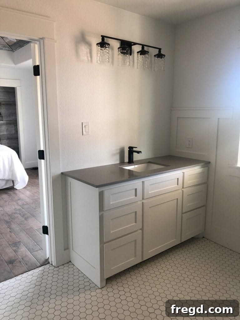 Paint Colors That Sell Your Flip House Fast 10 Bright master bathroom with Sherwin-Williams Pure White cabinets and dark accents