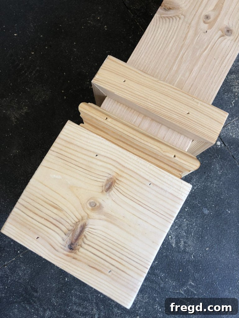 Close-up view of the applied casing trim on a table leg, showing the mitered corners.