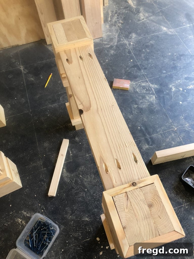 Detailed view of pocket hole screws securing two table leg assemblies together.