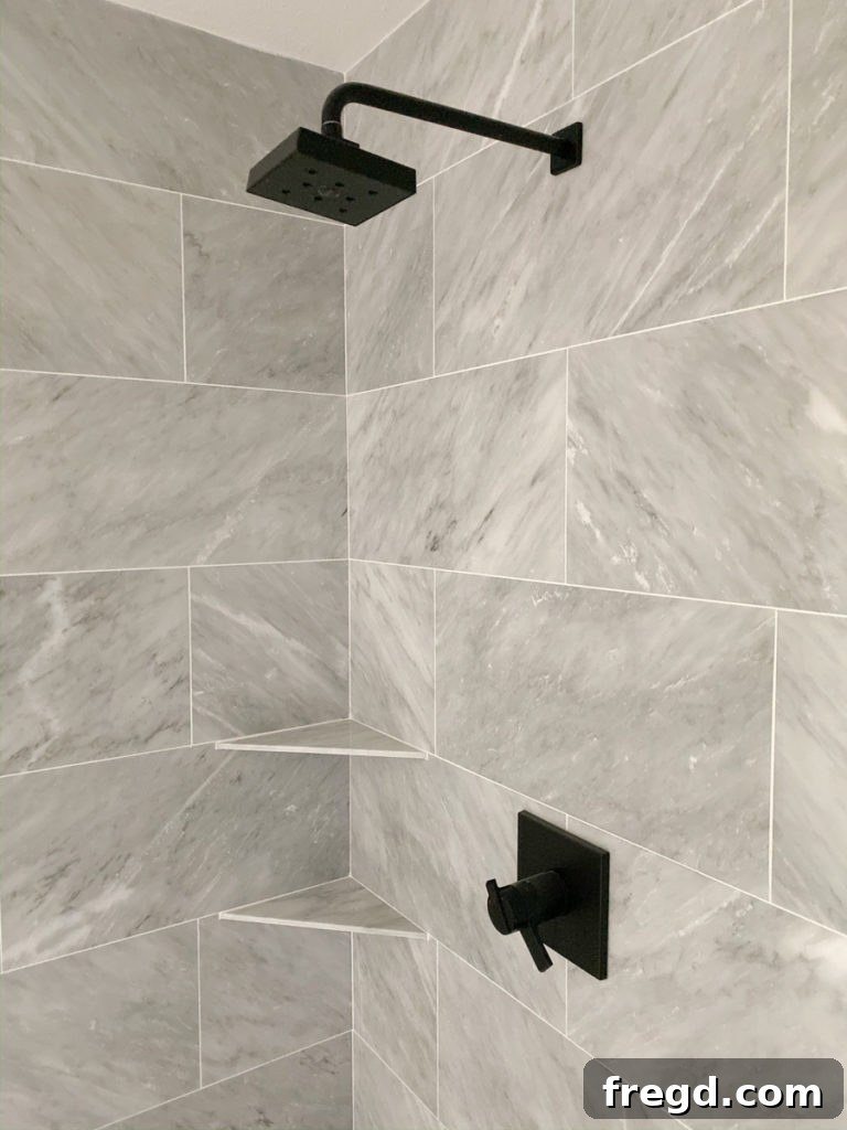 Full view of the master bathroom shower, showcasing the elegant marble tile and glass enclosure.
