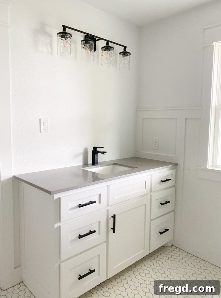Close-up of white matte hexagon tile floor in a master bathroom with grey grout.