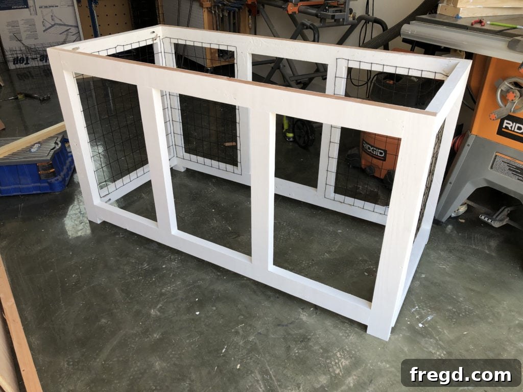 Attaching the front frame to the assembled dog kennel